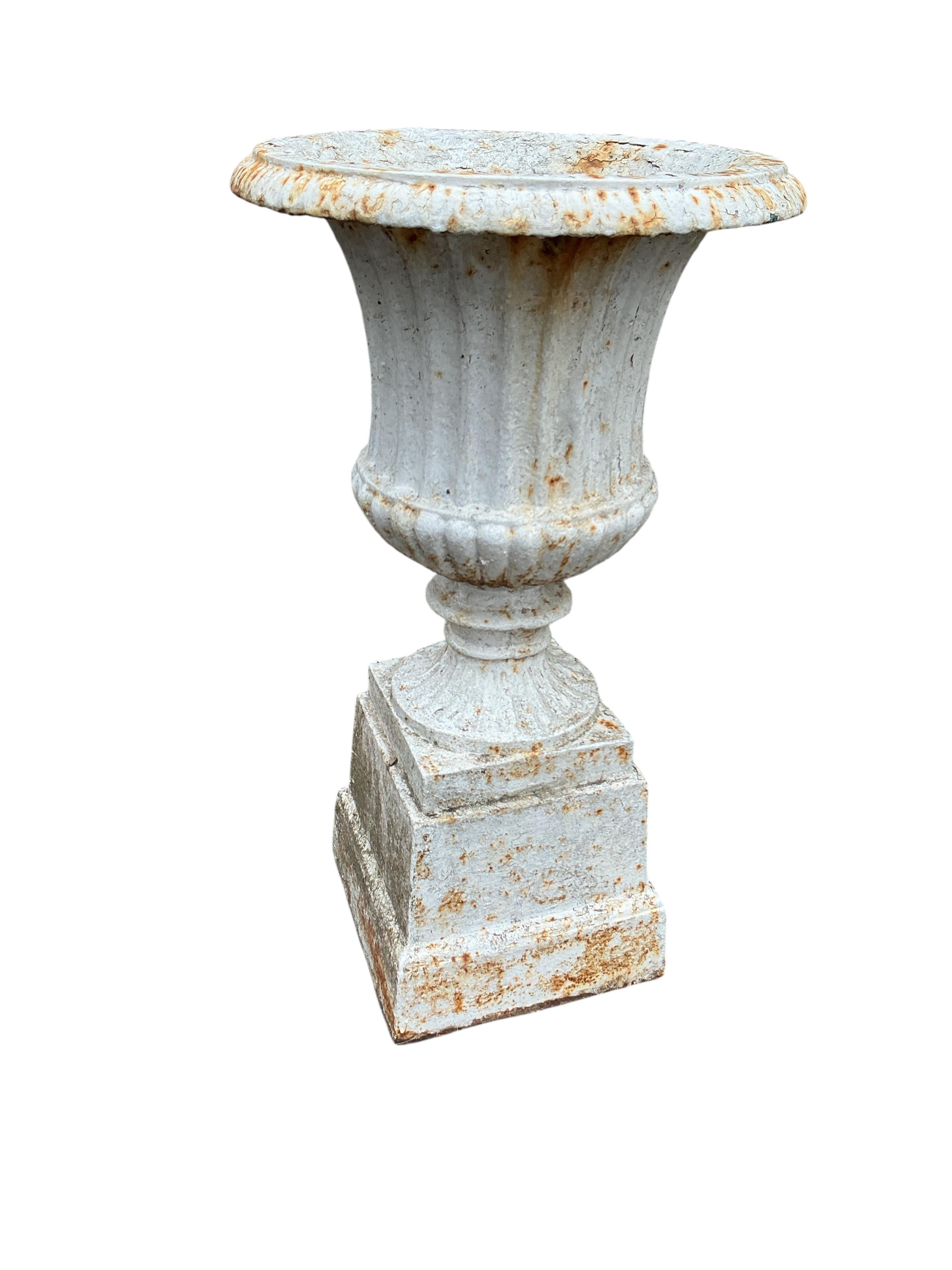 A pair of Victorian cast iron campana garden urns, on square bases, diameter 38cm, height 69cm